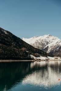 Glacial ice melting into rivers flowing through an alpine mountain landscape